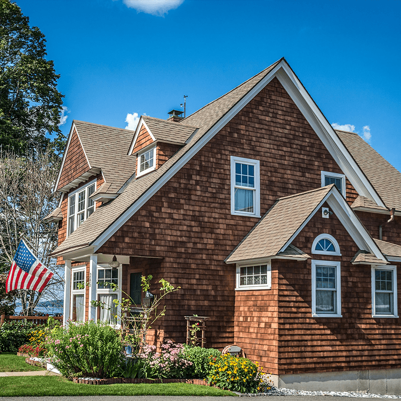 Brick cottage with an American flag. 