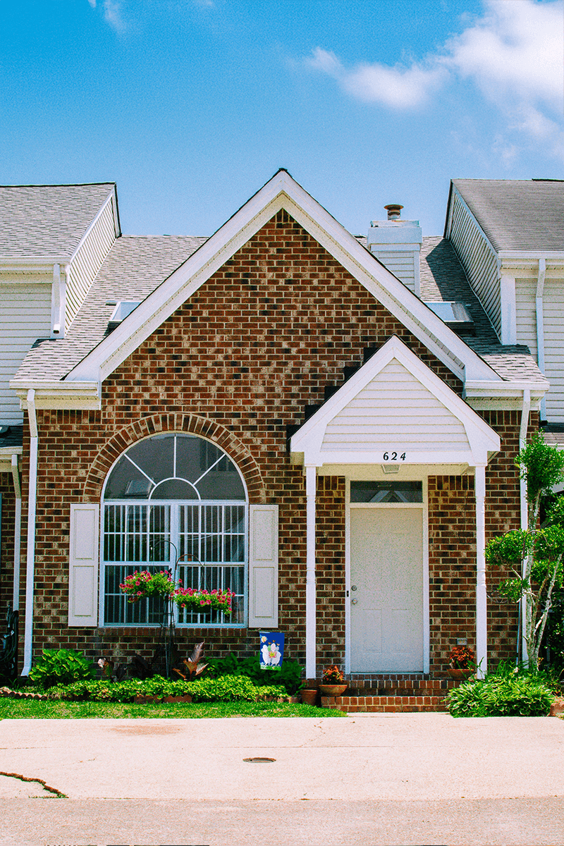 A red brick townhome with a white door