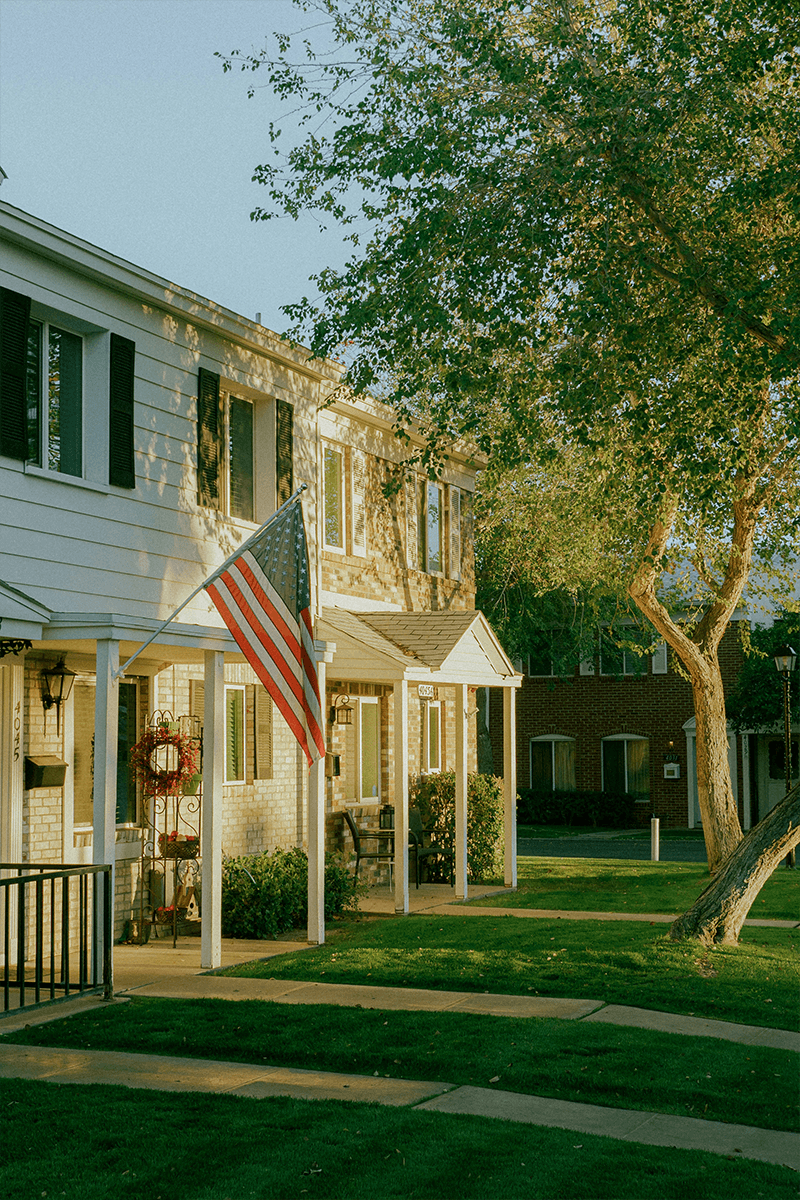A white house with an american flag on the front of it.